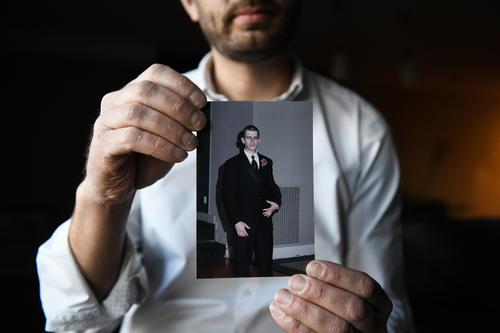 Ian Kalinowski holds a photo of his brother, Adam Kalinowski, on Wednesday, March 3, 2021. Adam died by suicide in 2014 while he was a client at a treatment center run by Addiction Specialists, Inc., in Fayette County, Pennsylvania.