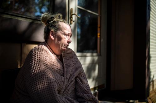 Laura Gallagher, of Langhorne, Pa., sits at the front of her home on Wednesday, Oct. 14, 2020.