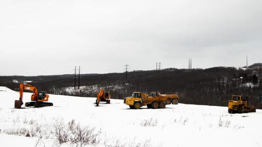 A high-voltage powerline runs behind a construction site in Archbald, PA.