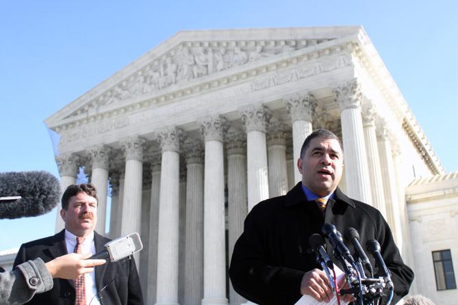 Citizens United President David Bossie (right) meets with reporters outside the U.S. Supreme Court.