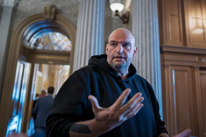 U.S. Sen. John Fetterman (D., Pa.) talks to reporters outside the chamber at the Capitol in Washington, March 13, 2025.
