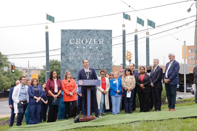 Gov. Josh Shapiro (center) joined health care workers, local leaders, and affected community members outside Crozer-Chester Medical Center in Delaware County.