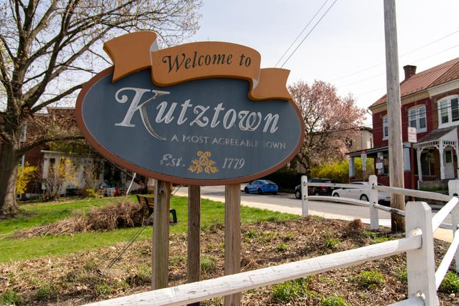 A sign for the borough of Kutztown that says ‘ a most agreeable town’ in faded letters
