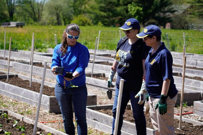 Garden of Health founder Carol Bauer and two other people at a farm.