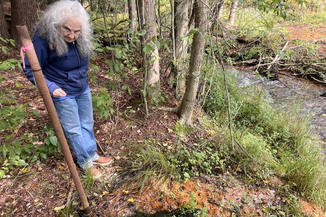 Bradford resident and retiree Barbara Laxon stands next to an abandoned, uncapped oil well. Bradford resident and retiree Barbara Laxon stands next to an abandoned, uncapped oil well.