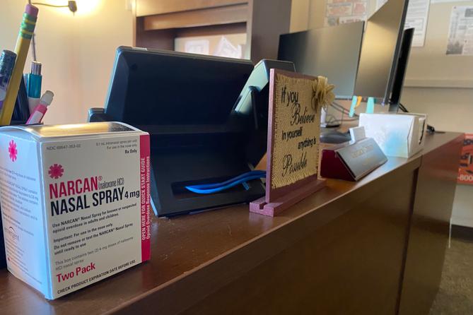 Sullivan County commissioners used a portion of opioid settlement money to hire a county case manager. Her desk includes a box of the opioid overdose-reversal drug Narcan.