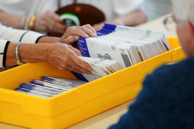 Workers sort mail ballots on primary Election Day 2024 at Northampton County Courthouse in Easton, Pennsylvania.