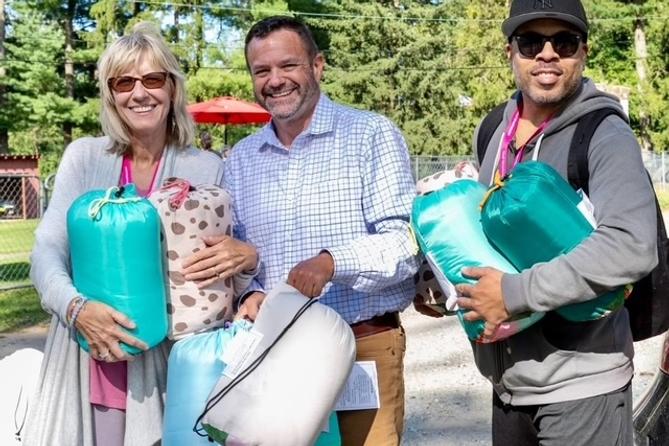 From left: Camp Dreamcatcher founder Patty Hillkirk, Kennett Square Mayor Matt Fetick, and Taj Brown. Fetick was delivering sleeping bags for campers.