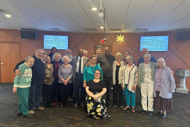 Mandy Mastros (center) surrounded by a group of Lancaster Moravian Church congregants.