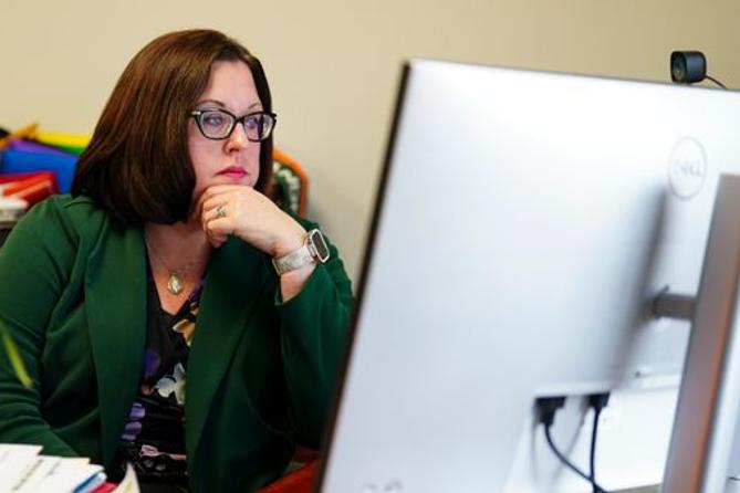 Scranton School District Superintendent Erin Keating looks at a computer on April 2, 2025, at the district’s administration building.