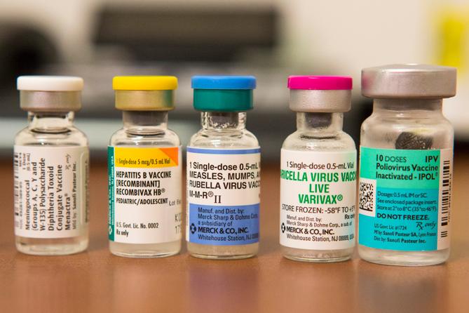 Vials containing vaccines for measles, hepatitis B, polio, and other diseases.