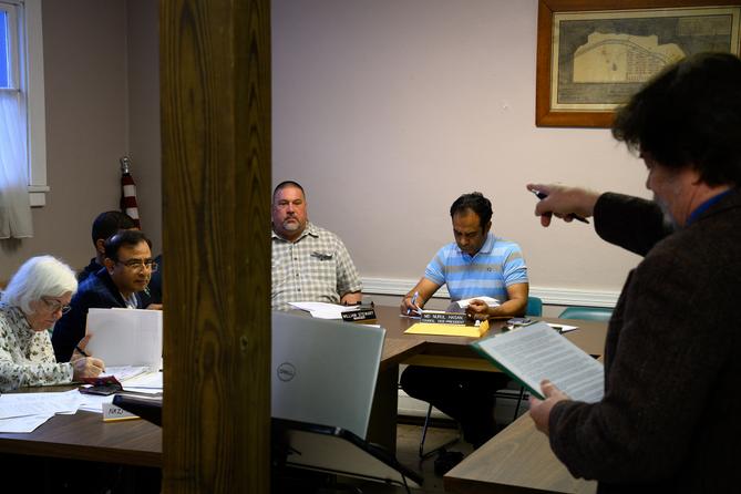 Tom Kramer, former mayor of Millbourne, points at Council Vice President Md Nurul Hasan during a council meeting.