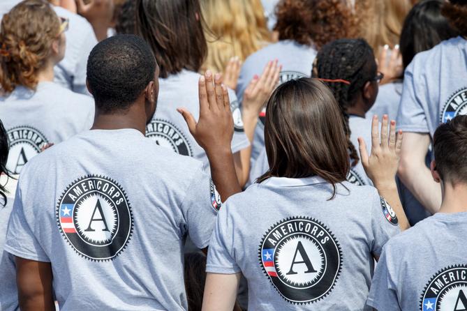 Hundreds of new AmeriCorps volunteers are sworn in for duty at a ceremony, Friday, Sept. 12, 2014, on the South Lawn of the White House in Washington.