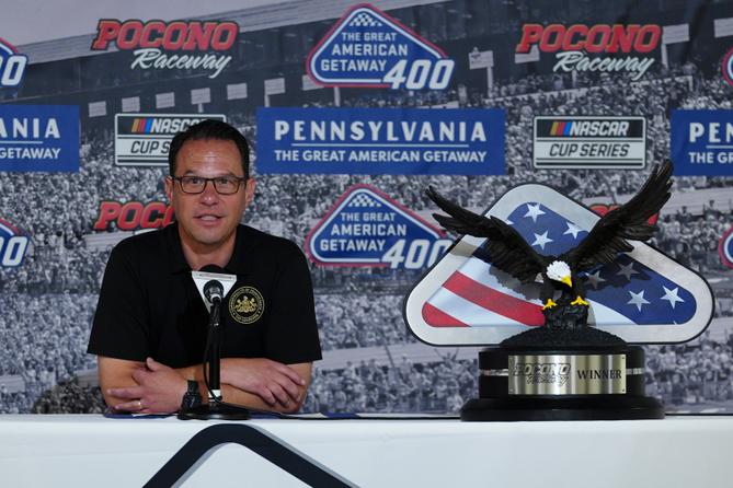 Gov. Josh Shapiro talks to the media prior to a NASCAR Cup Series auto race at Pocono Raceway.