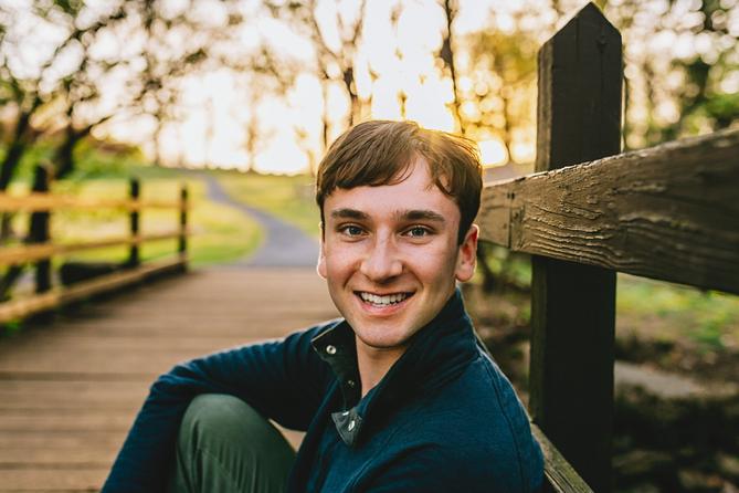 Young man at a bridge near the woods