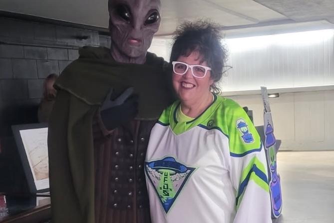 Carbondale Mayor Michele Bannon poses with an alien at a Carbondale UFOs — a one-night alternate identity for the Wilkes-Barre/Scranton Penguins — hockey game.