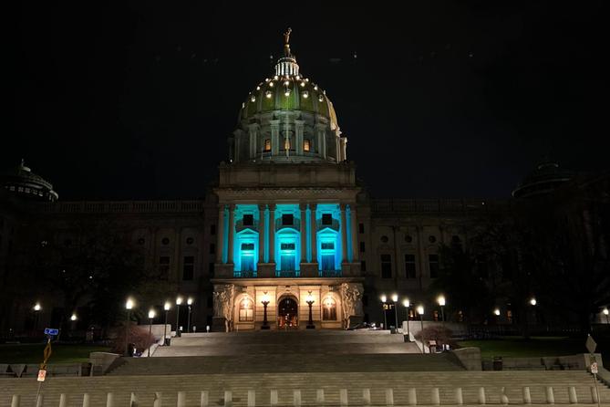 The Pennsylvania Capitol building illuminated in teal for Sexual Assault Awareness Month.