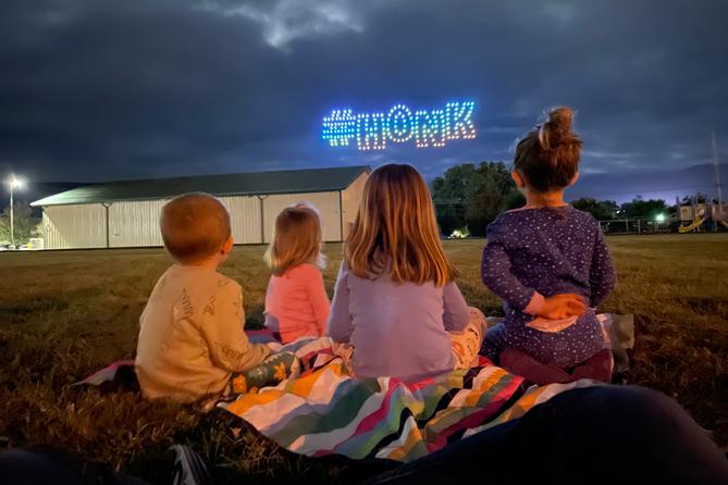 Children watch the inaugural Goose Day drone light show in downtown Lewistown in 2023.
