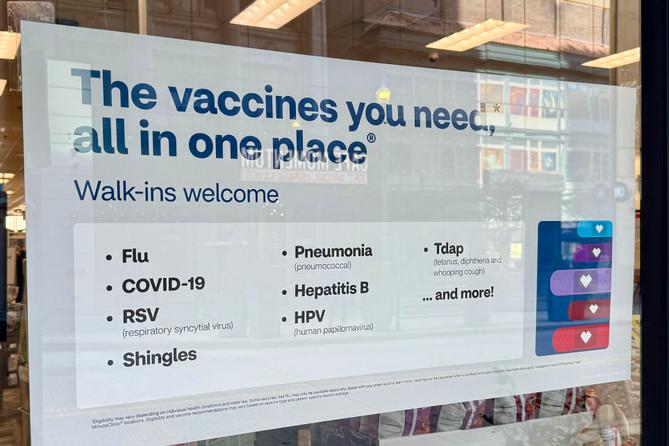 A flyer advertising vaccine services outside a CVS in Downtown Pittsburgh.