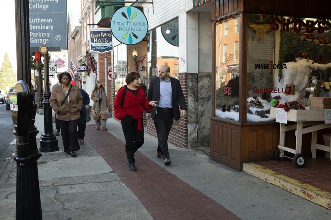 Department of Community and Economic Development Secretary Rick Siger (right) walks past shops in downtown Gettysburg, guided by Jill Sellers (left), president of Main Street Gettysburg. Department of Community and Economic Development Secretary Rick Siger (right) walks past shops in downtown Gettysburg, guided by Jill Sellers (left), president of Main Street Gettysburg.