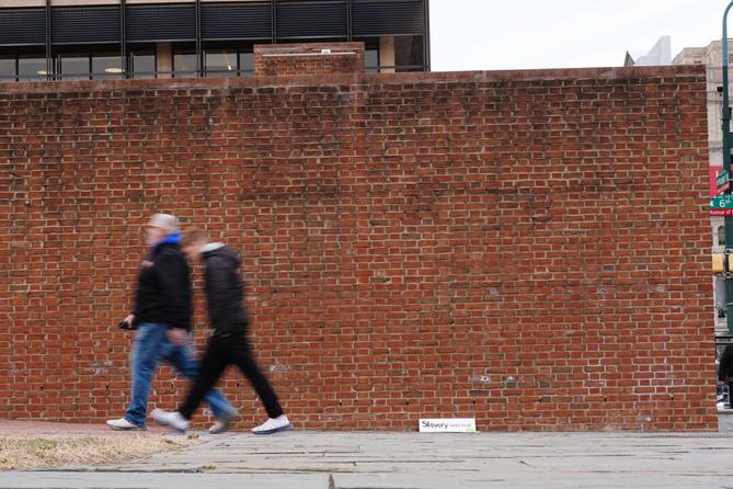 People walk past locations of the now removed explanatory panels that were part of an exhibit on slavery. People walk past locations of the now removed explanatory panels that were part of an exhibit on slavery.