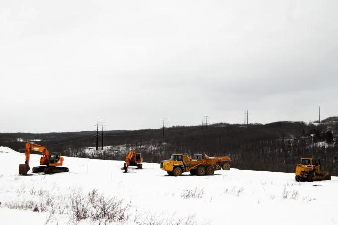 A high-voltage powerline runs behind a construction site in Archbald, PA.
