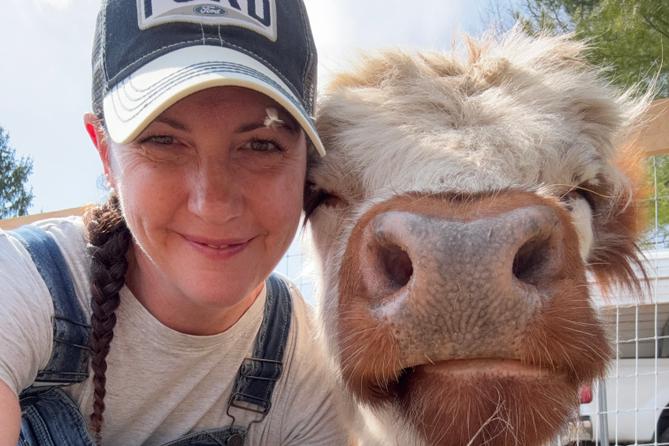 April Crossley with pet Highland cow April Crossley with pet Highland cow
