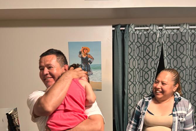 Erasmo Zavala hugs his granddaughter, Selene, as his wife Maria stands nearby. A picture of Selene’s mother, Selena, who was murdered, hangs behind the family. May 29, 2026. Erasmo Zavala hugs his granddaughter, Selene, as his wife Maria stands nearby. A picture of Selene’s mother, Selena, who was murdered, hangs behind the family. May 29, 2026.