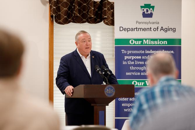 Pennsylvania Department of Aging Secretary Jason Kavulich speaks at a podium during an event, with a banner behind him outlining the department's mission to support older adults. Pennsylvania Department of Aging Secretary Jason Kavulich speaks at a podium during an event, with a banner behind him outlining the department's mission to support older adults.