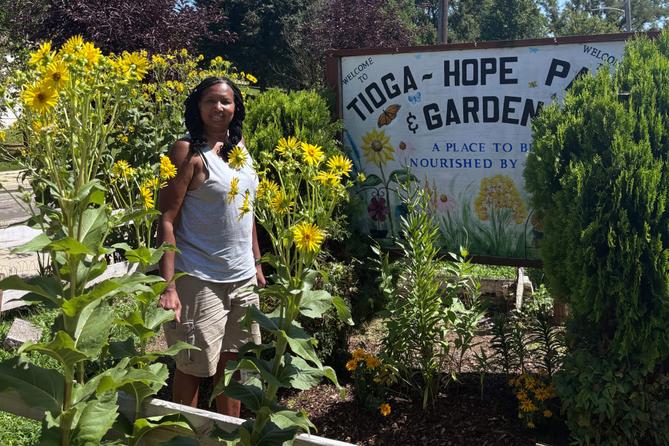 Philadelphia Gardener Estelle Vaughn stands among plants Philadelphia Gardener Estelle Vaughn stands among plants