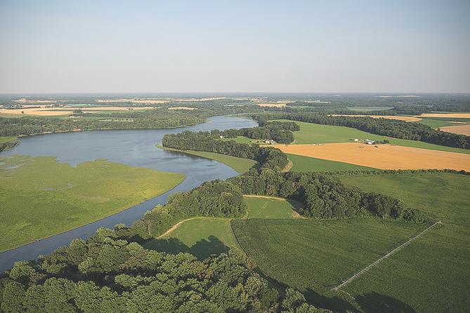 Farmland and marsh are nestled together along Tuckahoe Creek in Maryland. The creek flows into the Choptank River, which in turn enters the Chesapeake Bay. Farmland and marsh are nestled together along Tuckahoe Creek in Maryland. The creek flows into the Choptank River, which in turn enters the Chesapeake Bay.