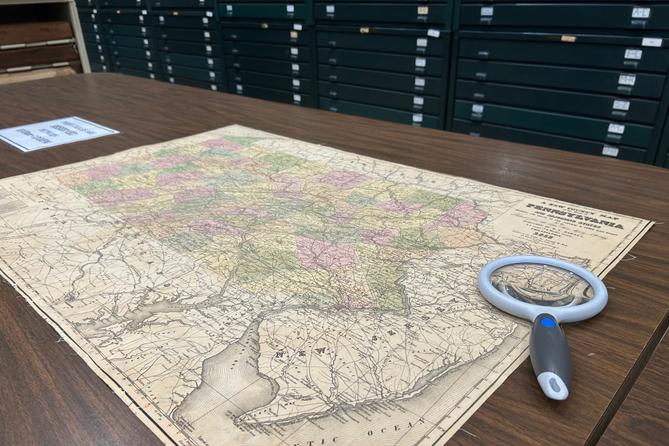 A map of Pennsylvania and a magnifying glass A map of Pennsylvania and a magnifying glass