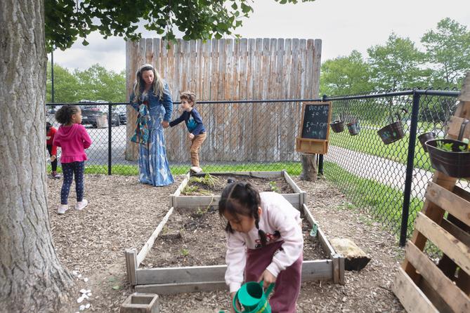 Diana McGuire leads her 4-year-old son Noah by the hand across the playground at St. Mary's Early Childhood Center in Indianapolis, Ind., May 13, 2026. Diana McGuire leads her 4-year-old son Noah by the hand across the playground at St. Mary's Early Childhood Center in Indianapolis, Ind., May 13, 2026.