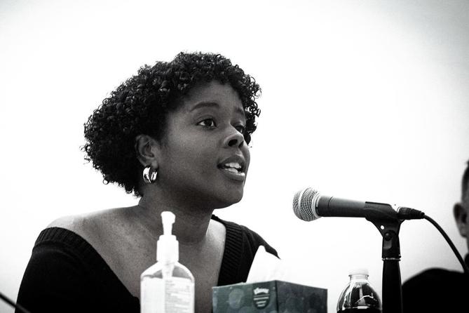 Jazmin Evans, a Philadelphia-based health advocate, speaks into a microphone. Jazmin Evans, a Philadelphia-based health advocate, speaks into a microphone.
