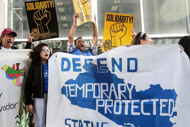 Supporters of temporary protected status immigrants hold signs and cheer at a rally in 2018. Supporters of temporary protected status immigrants hold signs and cheer at a rally in 2018.