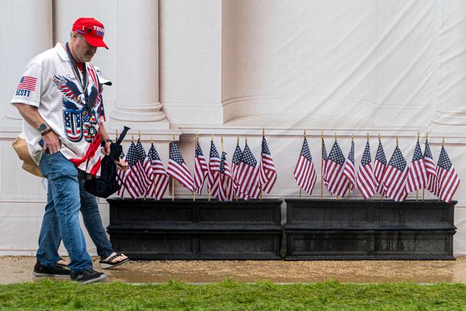 A man and woman in "Trump" hats walk through the Great American State Fair on the National Mall, in Washington.