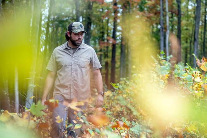 Kenny Kane, president of Generations Forestry, walks through saplings on a tract of forest land owned by the Bradford City Water Authority.