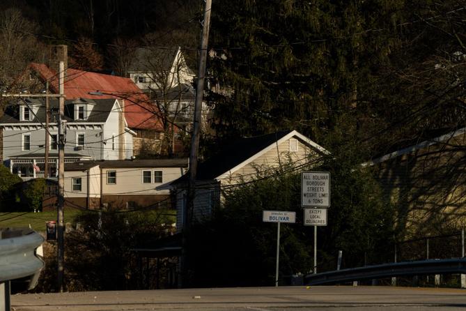 A sign greets drivers to Bolivar, Pennsylvania, with local homes in the background. It is the home of FAVOR ~ Western PA, which provides syringe services.