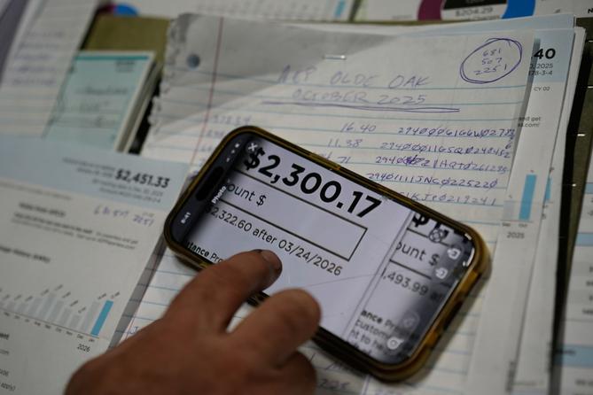 Eric Pinson, manager and resident of the Lock 24 RV Park and Campground, looks over the business' electric bills, at his home at the campground in Racine, Ohio.