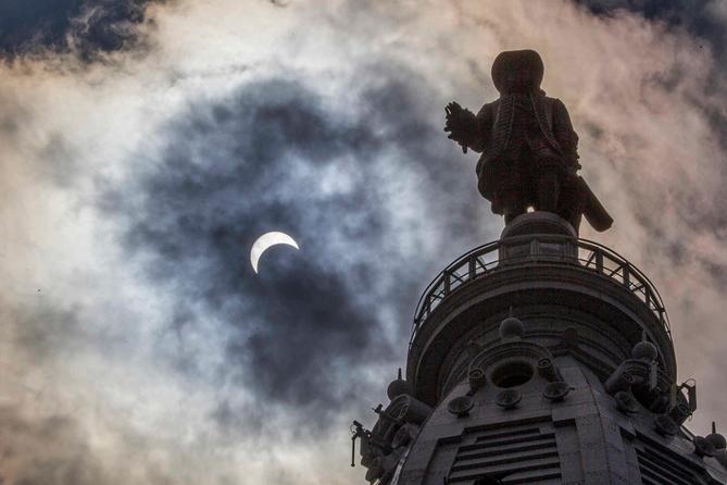 The statue of William Penn atop Philadelphia's City Hall is silhouetted by the partial solar eclipse in 2017.