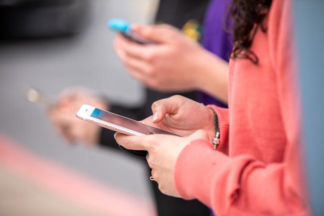 A person holds a cell phone.