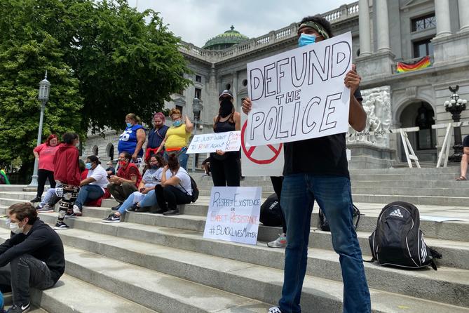 Kevin Buschan holds a sign at a demonstration demanding justice for George Floyd in Harrisburg on June 3, 2020.